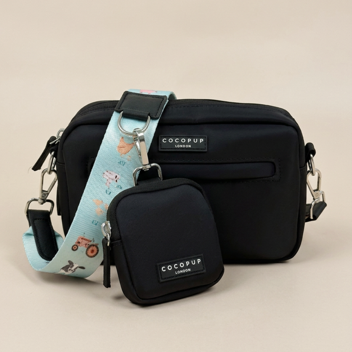Black Cocopup Dog Walking Bag with Treat Pouch attached and blue bag strap with farmyard animal print.