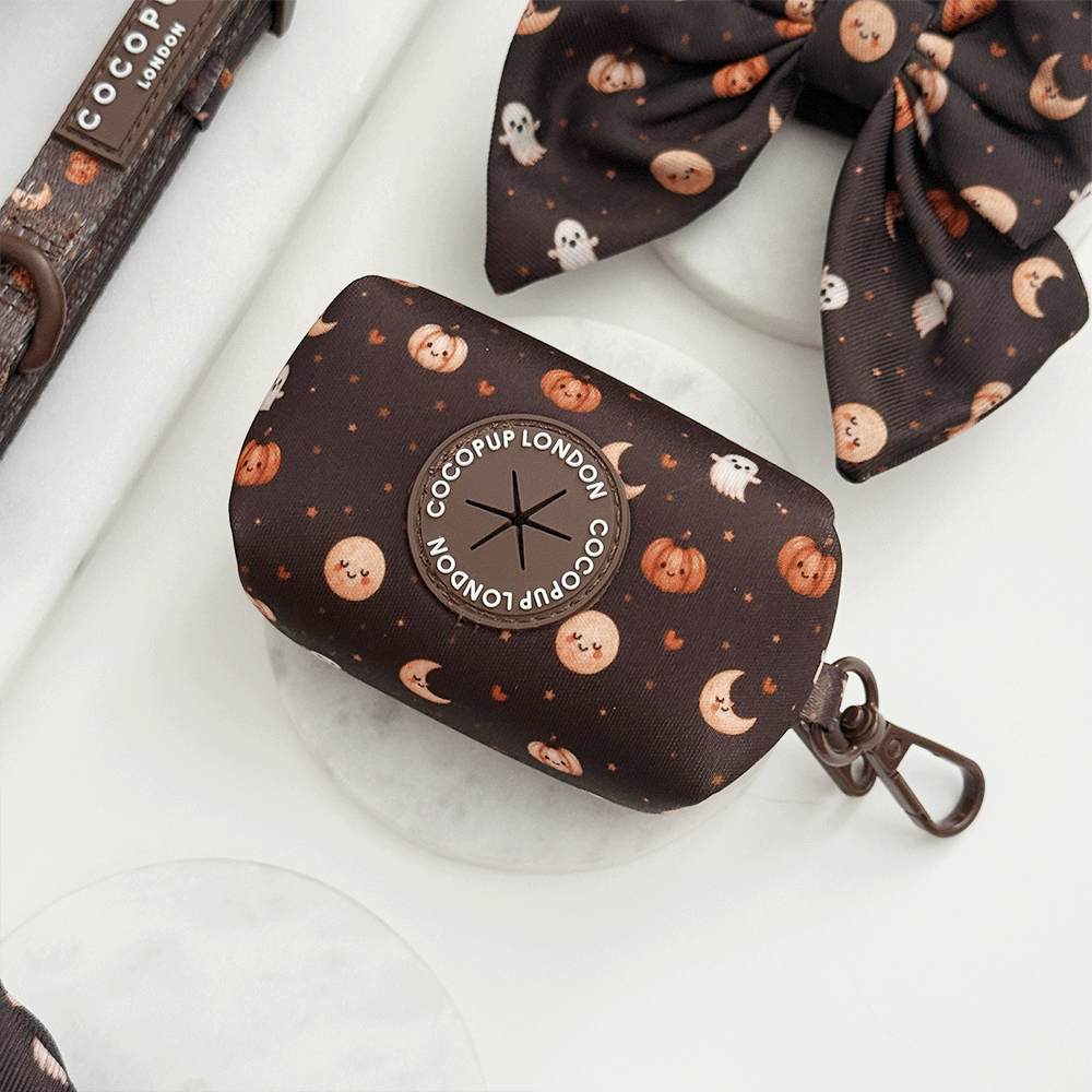 Brown poop bag holder, to hold dog poo bags, with cute Halloween print featuring pumpkins, ghosts, and moons.