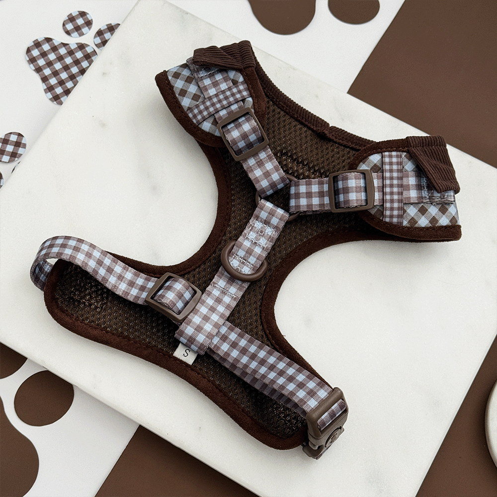 A brown and blue check print dog harness. With brown hardware.