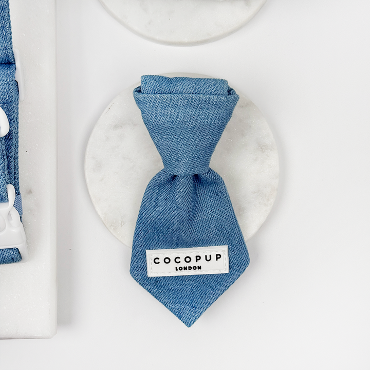 Blue denim dog tie with a Cocopup label on a white background