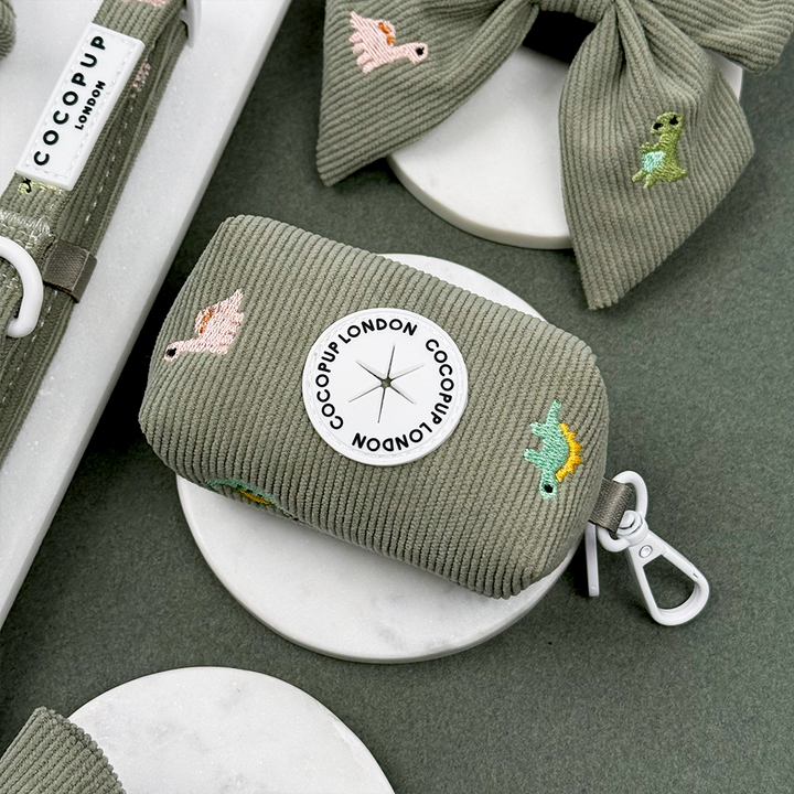 Green corduroy material Dog Poop Bag Holder with embroidered dinosaurs. 