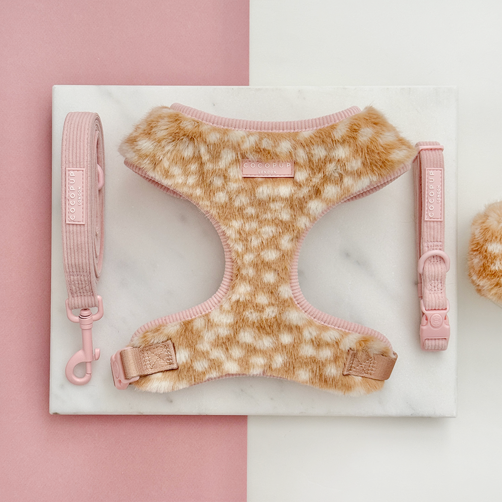 Faux fur dog harness in a beige and cream fawn pattern with pink ribbed lead and collar.