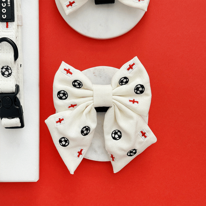 White Dog Sailor Bow Tie with embroidered footballs and England flags.