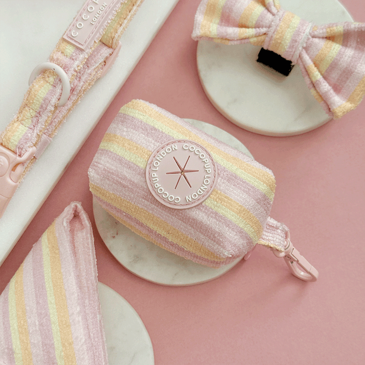 Pink, yellow and orange striped Poop Bag Holder designed to hold dog poo rolls. Features a handy dispenser to pull bags through. 