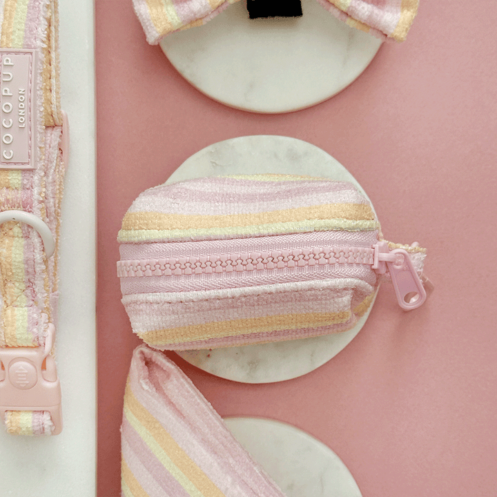 Pink, yellow and orange striped Dog Poop Bag Dispenser with pink Cocopup logo badge. With zip closure to hold two rolls of poo bags.