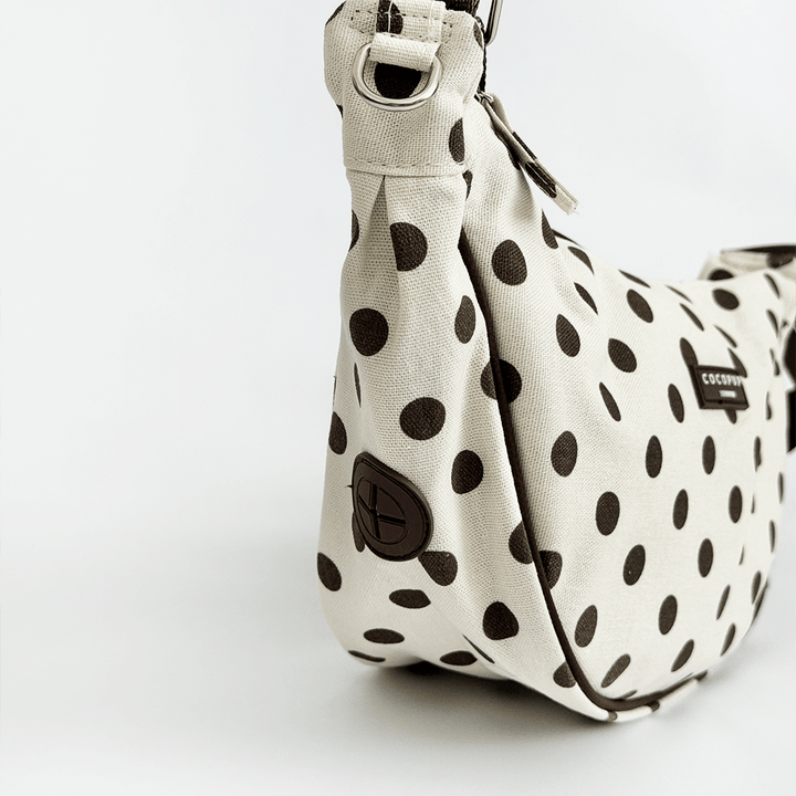 Polka dot handbag with a visible brand logo on a white background
