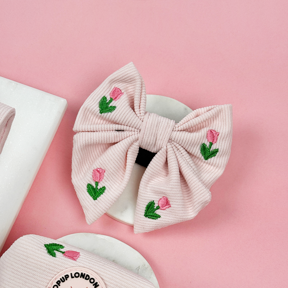 Pink dog bow tie with tulip embroidery design.