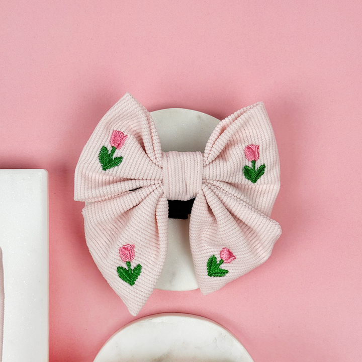 Pink dog bow tie with tulip embroidery.