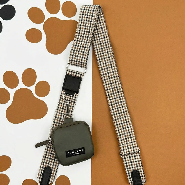Mocha dog walking bag with plaid strap and green poop bag holder featuring a paw print, from Cocopup London.