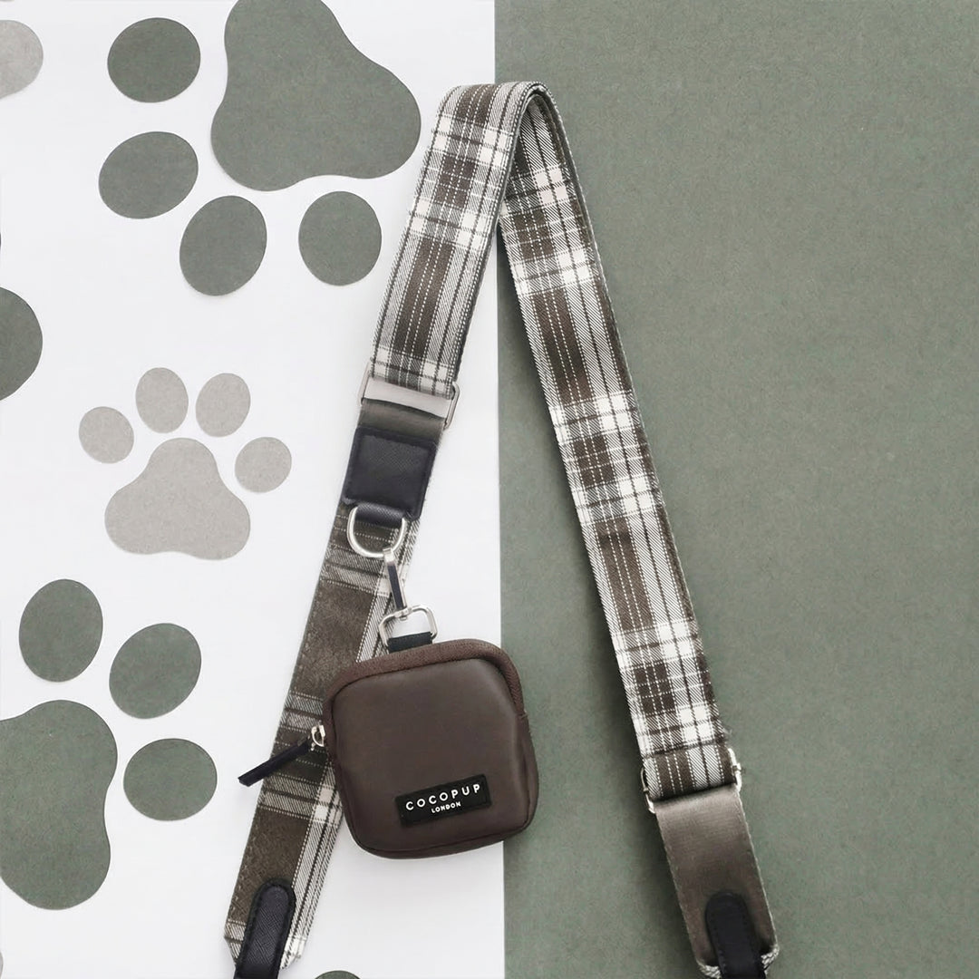 Mocha brown Cocopup London dog walking bag displayed on a background split between paw print and solid green.