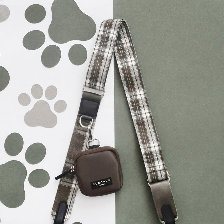 Mocha brown Cocopup London dog walking bag displayed on a background split between paw print and solid green.