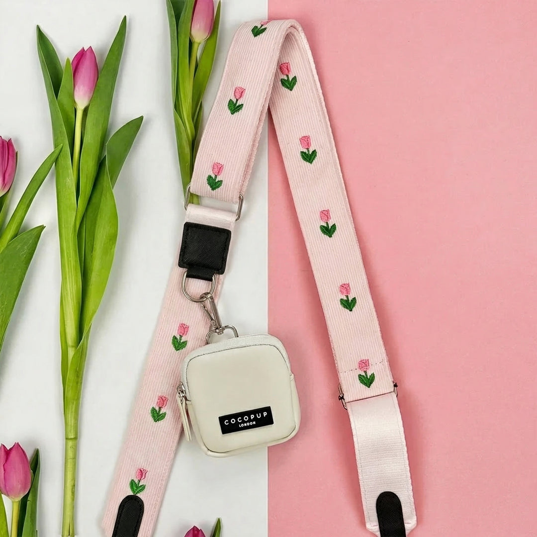 Oyster white dog walking bag with a pink strap and tulip pattern from Cocopup London.